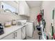 Functional laundry room with plenty of counter space, storage cabinets, and modern washer/dryer at 1113 Fieldstone Cir, Oviedo, FL 32765