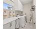 Well-organized laundry room with washer, dryer, and storage solutions at 1113 Fieldstone Cir, Oviedo, FL 32765