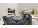 Spacious living room featuring a large sectional sofa, media console, and sliding glass doors to the backyard at 1113 Fieldstone Cir, Oviedo, FL 32765