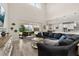 Inviting living room with a large sectional sofa, high ceilings, and sliding glass doors to the backyard at 1113 Fieldstone Cir, Oviedo, FL 32765