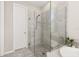 Main bathroom has a glass enclosed tiled shower with shower seat, and neutral paint and tiles at 1113 Fieldstone Cir, Oviedo, FL 32765