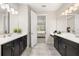 The main bathroom features double sinks, tiled floors, and an open doorway leading to the main bedroom at 1113 Fieldstone Cir, Oviedo, FL 32765