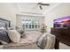Relaxing main bedroom with ceiling fan, plantation shutters, and stylish furniture for a comfortable living space at 1113 Fieldstone Cir, Oviedo, FL 32765