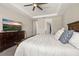 Main bedroom boasts a dresser with TV, neutral walls and carpet, leading to the bathroom and closet at 1113 Fieldstone Cir, Oviedo, FL 32765