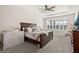Bright main bedroom with tray ceilings, plantation shutters, and neutral colors creating a serene retreat at 1113 Fieldstone Cir, Oviedo, FL 32765
