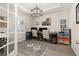 Bright home office featuring tray ceilings, wood floors, and a stylish decor at 1113 Fieldstone Cir, Oviedo, FL 32765