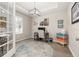 Bright office space with stylish lighting, neutral walls, and a round area rug at 1113 Fieldstone Cir, Oviedo, FL 32765