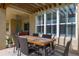 Inviting outdoor patio with a wooden table and seating, offering a relaxing space for gatherings and relaxation at 1113 Fieldstone Cir, Oviedo, FL 32765
