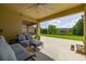 Spacious covered patio with outdoor seating overlooking a beautifully landscaped backyard and scenic pond view at 1113 Fieldstone Cir, Oviedo, FL 32765