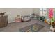 Bright playroom featuring a colorful hopscotch rug, toddler bunkbed, and various toys at 1113 Fieldstone Cir, Oviedo, FL 32765