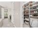 Spacious walk-in closet with custom shelving, shoe racks, and easy access to the en-suite bathroom at 1113 Fieldstone Cir, Oviedo, FL 32765