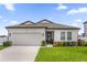 Charming single-story home with a well-manicured lawn, two-car garage, and welcoming front entrance at 1203 Pearl Tree Rd, Deltona, FL 32725