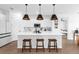 Modern kitchen with white cabinets, a large island with seating, and stainless steel appliances at 1203 Pearl Tree Rd, Deltona, FL 32725