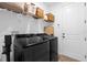 Efficient laundry room with modern appliances, overhead shelving, and ample storage space at 1203 Pearl Tree Rd, Deltona, FL 32725