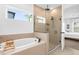 Luxurious main bathroom with a soaking tub, a separate glass shower, and natural light at 1203 Pearl Tree Rd, Deltona, FL 32725