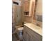 This bathroom features a shower-tub combination, a toilet, and sink with vanity storage and open shelving for convenience and organization at 125 Darlene Ct, Davenport, FL 33897