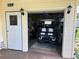 A spacious garage interior with an electric golf cart, tools and work bench, and storage at 125 Darlene Ct, Davenport, FL 33897