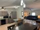 The kitchen features stainless steel appliances and an eat-in counter open to the living room at 125 Darlene Ct, Davenport, FL 33897