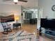 View into the living room, featuring a modern couch, rocking chair, and an entertainment center at 125 Darlene Ct, Davenport, FL 33897