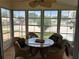 A covered patio offers natural light, a glass top table, and neighborhood views at 125 Darlene Ct, Davenport, FL 33897