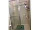 A view of a walk-in shower with sliding glass doors and updated shower head at 125 Darlene Ct, Davenport, FL 33897