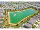 Aerial view showcases a community with a pond, fountain, and well-manicured landscaping at 129 Eagleview Loop, Davenport, FL 33837