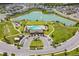 Aerial view of a community featuring a pool, playground, lake, and clubhouse at 129 Eagleview Loop, Davenport, FL 33837