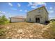 View of the backyard with a two-story home featuring sliding glass doors and an AC unit at 129 Eagleview Loop, Davenport, FL 33837