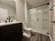 Modern bathroom features a sleek vanity and a glass-enclosed shower with built-in shelving at 129 Eagleview Loop, Davenport, FL 33837