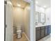 Bathroom featuring double vanity with modern fixtures, quartz countertops, and separate toilet room at 129 Eagleview Loop, Davenport, FL 33837
