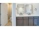 Bathroom featuring a double vanity with quartz countertops and modern fixtures at 129 Eagleview Loop, Davenport, FL 33837