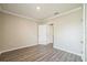 A bedroom featuring laminate flooring, base trim, and a white door at 129 Eagleview Loop, Davenport, FL 33837