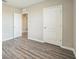 Neutral bedroom with two closets and wood-look floors at 129 Eagleview Loop, Davenport, FL 33837