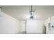 A two car garage featuring a door and a water heater at 129 Eagleview Loop, Davenport, FL 33837