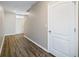 Hallway with wood-look flooring, white door and trim at 129 Eagleview Loop, Davenport, FL 33837