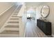 Inviting hallway with staircase, modern flooring, and stylish console table at 129 Eagleview Loop, Davenport, FL 33837