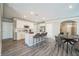 Bright kitchen features white cabinetry, stainless appliances, and a large center island with barstool seating at 129 Eagleview Loop, Davenport, FL 33837