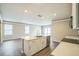 Bright kitchen features white cabinetry, stainless appliances, and a large center island at 129 Eagleview Loop, Davenport, FL 33837