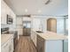 Bright kitchen features white cabinetry, stainless appliances, and a large center island at 129 Eagleview Loop, Davenport, FL 33837