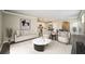 Open-concept living room showcasing contemporary furnishings and a view into the adjacent kitchen at 129 Eagleview Loop, Davenport, FL 33837