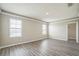 Well-lit bedroom with wood-look floors, white trim, and windows for natural light at 129 Eagleview Loop, Davenport, FL 33837