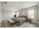 Well-lit primary bedroom featuring neutral walls, and wood-look flooring at 129 Eagleview Loop, Davenport, FL 33837