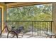 Balcony overlooking green trees with a bicycle and small table set at 1321 Arbor Vista Loop # 301, Lake Mary, FL 32746