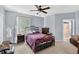 Comfortable bedroom featuring a decorative metal bed frame and natural light from the windows at 1321 Arbor Vista Loop # 301, Lake Mary, FL 32746