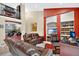 View of the living room, with the kitchen and a leather sofa at 1321 Arbor Vista Loop # 301, Lake Mary, FL 32746