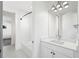 A pristine white bathroom featuring a shower-tub combo and hexagon-tile flooring at 1414 W New Hampshire St, Orlando, FL 32804