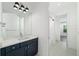 Modern bathroom features double sinks, a large mirror with decorative lighting and shower-tub access at 1414 W New Hampshire St, Orlando, FL 32804