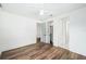 Cozy bedroom with hardwood floors and a ceiling fan, featuring doors to closets and bath at 1414 W New Hampshire St, Orlando, FL 32804