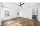 Sunlit bedroom featuring hardwood floors, a ceiling fan, and board and batten accent wall at 1414 W New Hampshire St, Orlando, FL 32804