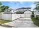 A modern two-story home with brick-paved driveway and white privacy fence at 1414 W New Hampshire St, Orlando, FL 32804
